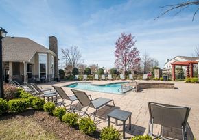 Memphis apartment for rent - A backyard with a pool and lounge chairs.