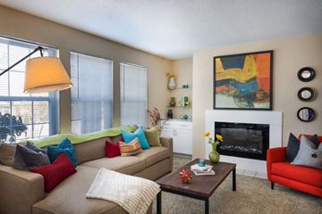 Louisville apartment for rent - A living room with a fireplace and a painting on the wall.