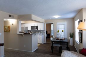 Louisville apartment for rent - A well-lit kitchen with a dining table and chairs.