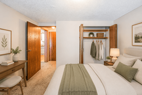 Miamisburg apartment for rent - A bedroom with a bed, desk, and chair.