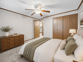 Louisville apartment for rent - A bedroom with a bed, dresser, and ceiling fan.
