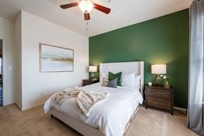 Columbus townhouse for rent - a bedroom with a bed and a ceiling fan