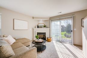 Blacklick townhouse for rent - a living room with a couch and a fireplace and a sliding glass door