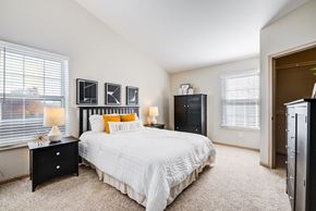 Blacklick townhouse for rent - a bedroom with a large bed and two windows