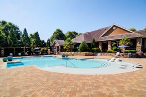 Mcdonough apartment for rent - a large swimming pool with a house in the background