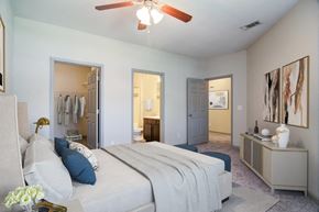 Mcdonough apartment for rent - a bedroom with a large bed and a ceiling fan