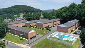 Reading apartment for rent - an aerial view of a brick building with a swimming pool