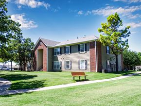 Broken Arrow apartment for rent - A building with a bench in front of it.
