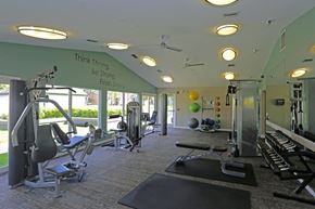 West Palm Beach apartment for rent - A gym with a variety of equipment and a motivational quote on the wall.