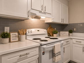 Rock Hill apartment for rent - A kitchen with a white stove top oven and white cabinets.