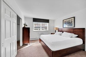 Carlisle apartment for rent - a bedroom with a large bed and a window