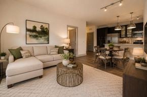 Greenville apartment for rent - A modern living room with a white sofa and a coffee table.