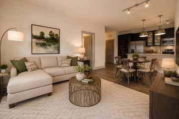 Greenville apartment for rent - A modern living room with a white sofa and a coffee table.