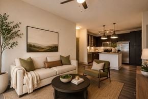Greenville apartment for rent - A living room with a white couch and a painting on the wall.