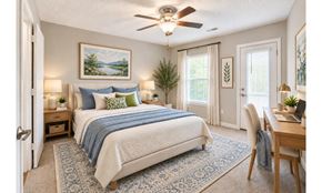 High Point apartment for rent - A bedroom with a bed, a desk, and a ceiling fan.