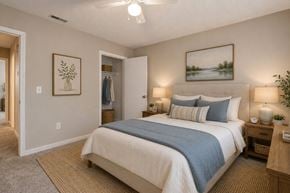 Huntersville apartment for rent - A bedroom with a large bed and a painting on the wall.