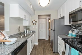 Indianapolis townhouse for rent - a kitchen with granite counter tops and stainless steel appliances