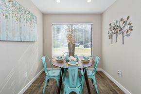 Indianapolis townhouse for rent - a dining room with a table and chairs and a window