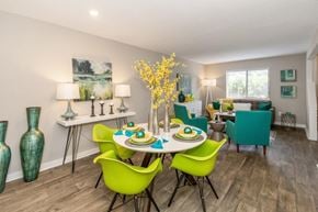 Indianapolis townhouse for rent - A dining room with a table set for four and green chairs.