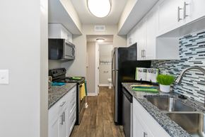 Indianapolis townhouse for rent - A kitchen with a black refrigerator and a black microwave.