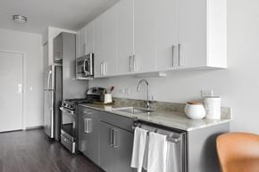 Chicago apartment for rent - A modern kitchen with a stainless steel refrigerator and oven.