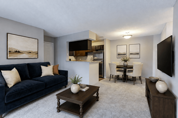 Schaumburg apartment for rent - A living room with a blue couch and a painting on the wall.