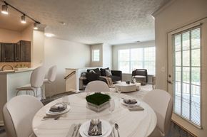 Beavercreek apartment for rent - a living room and dining room with a white table and chairs