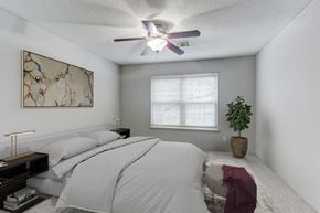 Schaumburg apartment for rent - a bedroom with a bed and a ceiling fan