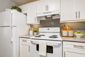 Salisbury apartment for rent - A white stove with a white oven and a white refrigerator in a kitchen.