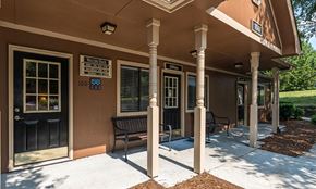 Concord apartment for rent - a building with a porch and benches outside of it