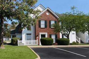 Centerville apartment for rent - A white house with a red brick chimney and black shutters.