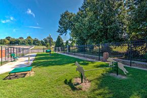 Tulsa apartment for rent - A park with a green bench and a playground.