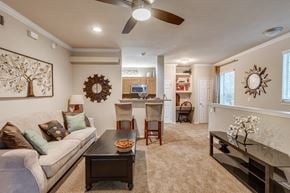 Tulsa apartment for rent - A living room with a couch, coffee table, and a ceiling fan.
