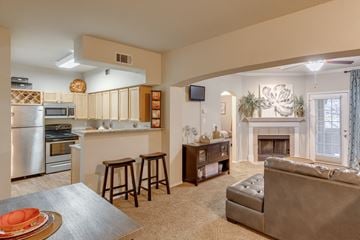 Tulsa apartment for rent - A modern kitchen with a dining table and a couch.