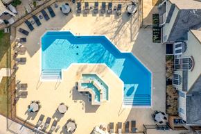Tulsa apartment for rent - A large swimming pool with a slide and a hot tub.