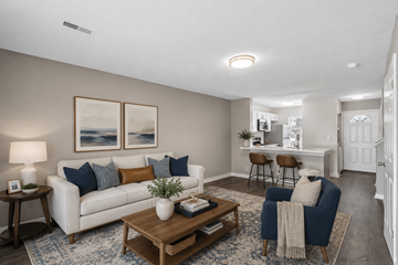 Middletown apartment for rent - A living room with a white couch, a coffee table, and a painting on the wall.