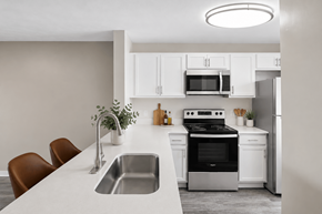 Middletown apartment for rent - A modern kitchen with white cabinets and appliances.