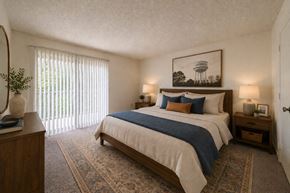 Fayetteville apartment for rent - A bedroom with a bed, nightstands, and a painting on the wall.
