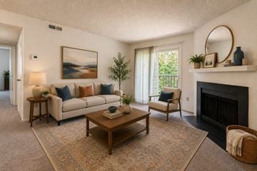 Fayetteville apartment for rent - A living room with a fireplace and a painting on the wall.