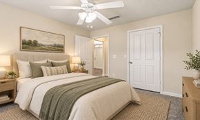 Augusta apartment for rent - A bedroom with a large bed and a painting on the wall.