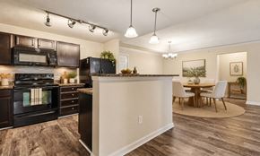 Augusta apartment for rent - A modern kitchen with dark brown cabinets and a wooden floor.