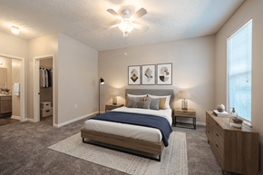 Fayetteville apartment for rent - A bedroom with a bed, nightstand, and a ceiling fan.
