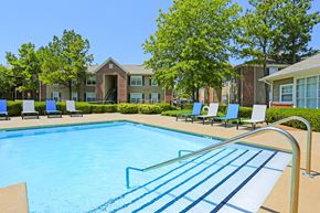 Broken Arrow apartment for rent - A swimming pool with a metal ladder in the middle of it.