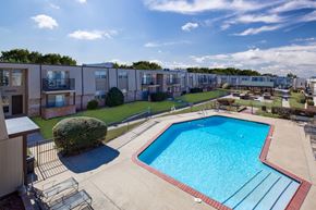 Bethany apartment for rent - A swimming pool in a sunny day surrounded by a fence.