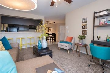 Manchester apartment for rent - A living room with a blue chair and a grey couch.