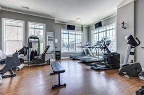 Cornelius apartment for rent - A spacious gym with a variety of equipment including treadmills, stationary bikes, and weight machines.