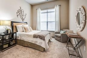 Cornelius apartment for rent - A bedroom with a large bed and a chair.