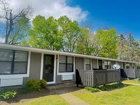 Louisville apartment for rent - A row of houses with green trees in the background.