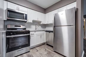 Allentown apartment for rent - A modern kitchen with a stainless steel refrigerator, microwave, and oven.