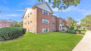 Allentown apartment for rent - A red brick building with a green lawn in front.